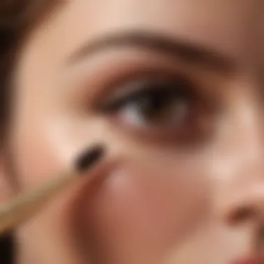 Close-up of brown mascara wand application