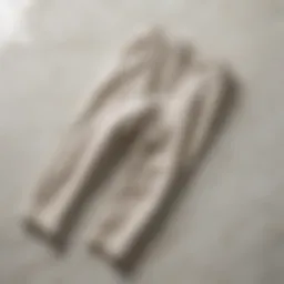 Elegant linen pants folded on marble surface