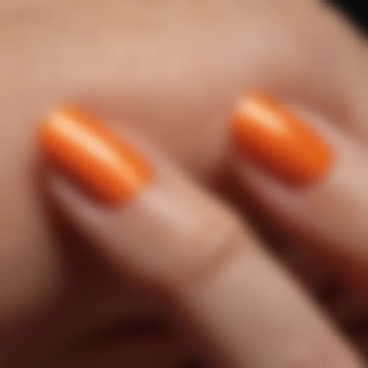 Close-up of an orange nail polish application technique.