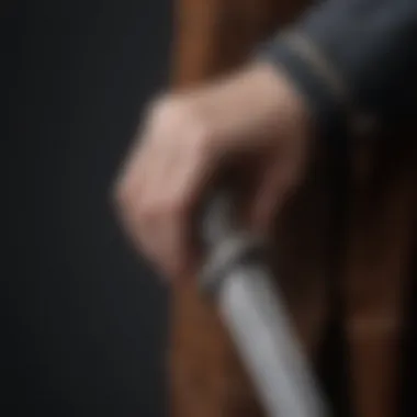 A close-up of a character's hand holding a traditional Scottish dagger.